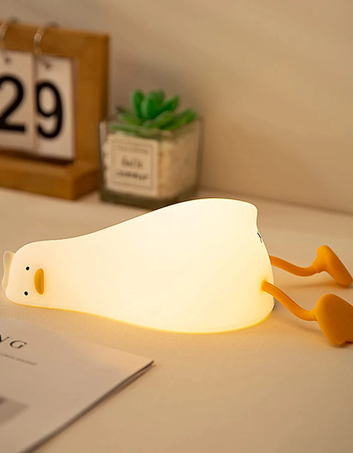 Load image into Gallery viewer, Lying Flat Duck Night Light, LED Squishy Duck Lamp, Cute Light up Duck, Silicone Dimmable Nursery Nightlight, Rechargeable Bedside Touch Lamp for Breastfeeding, Finn the Duck.
